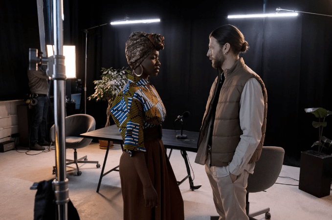 woman-in-white-blazer-standing-beside-woman-in-brown-dress