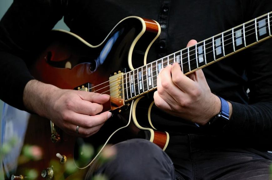 person playing an electric guitar