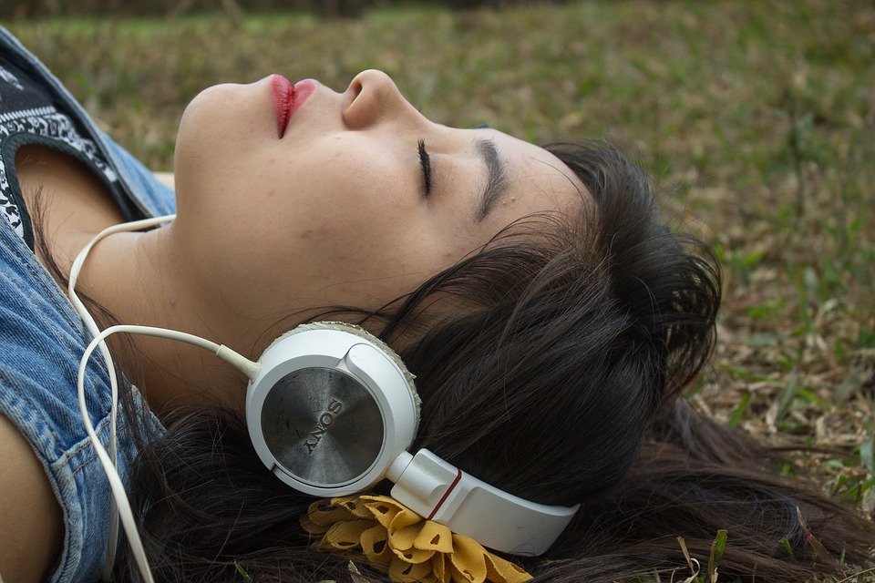 Girl listening to music with headphone