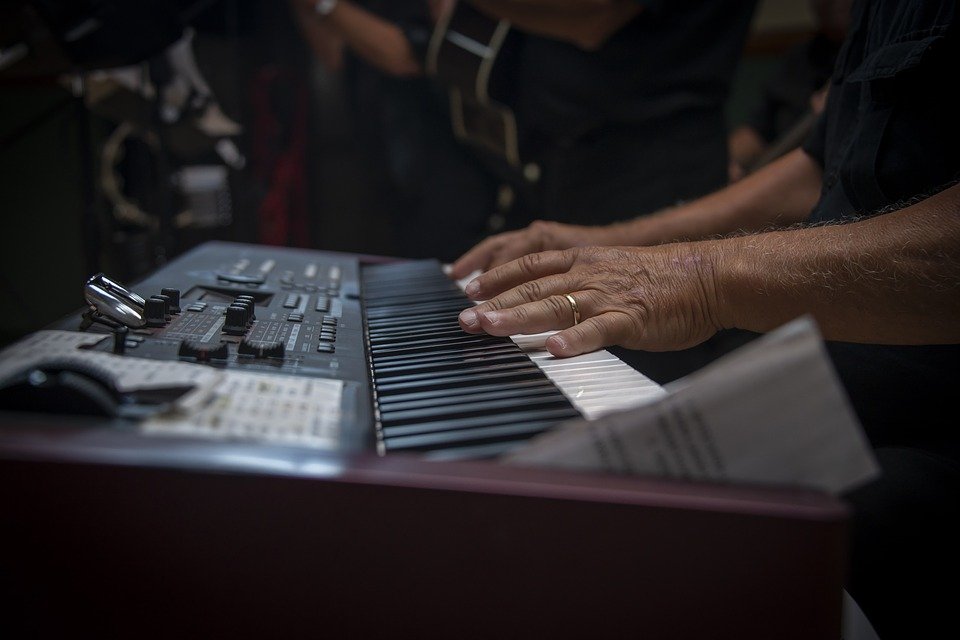 playing a keyboard in a band
