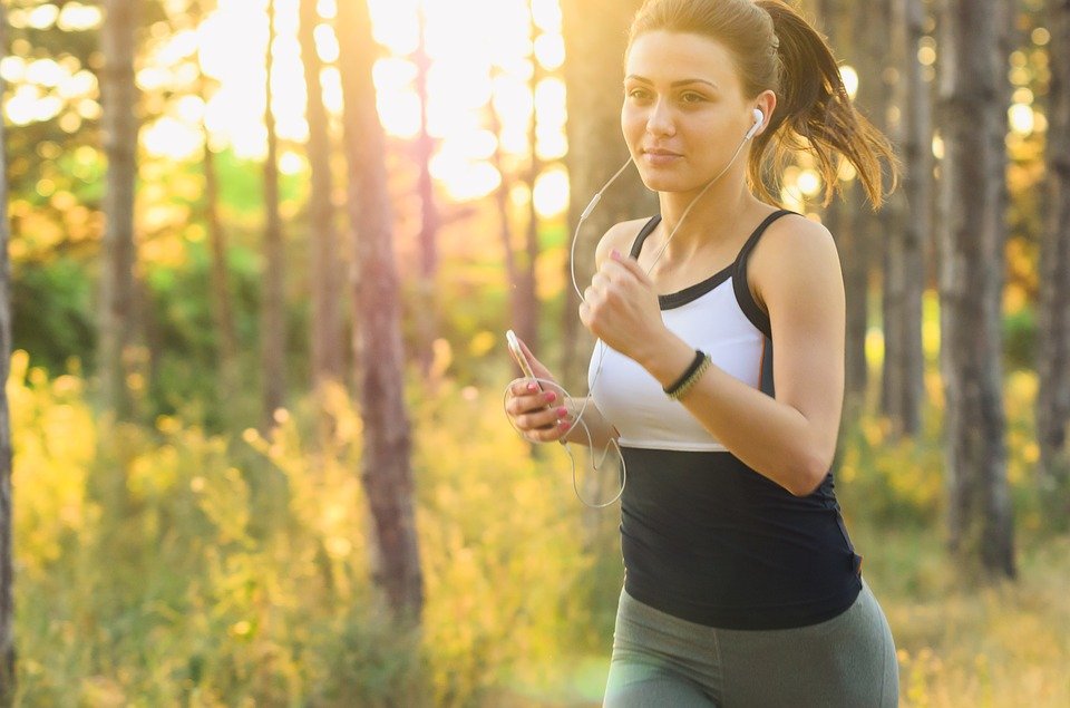 woman exercising while listening to music