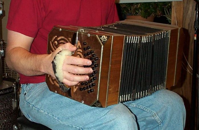 A photo of a man playing the bandoneon