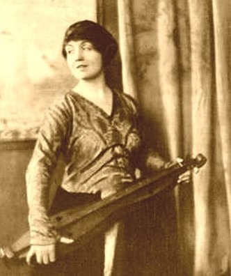 A photo of a woman holding the dulcimer