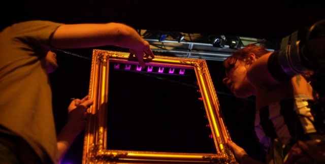Setting up a framed laser harp before a show