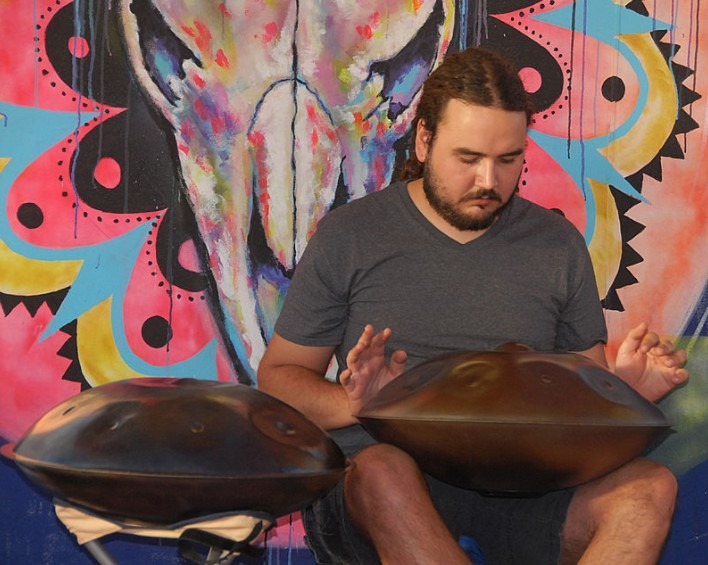 A photo of a musician playing the handpan