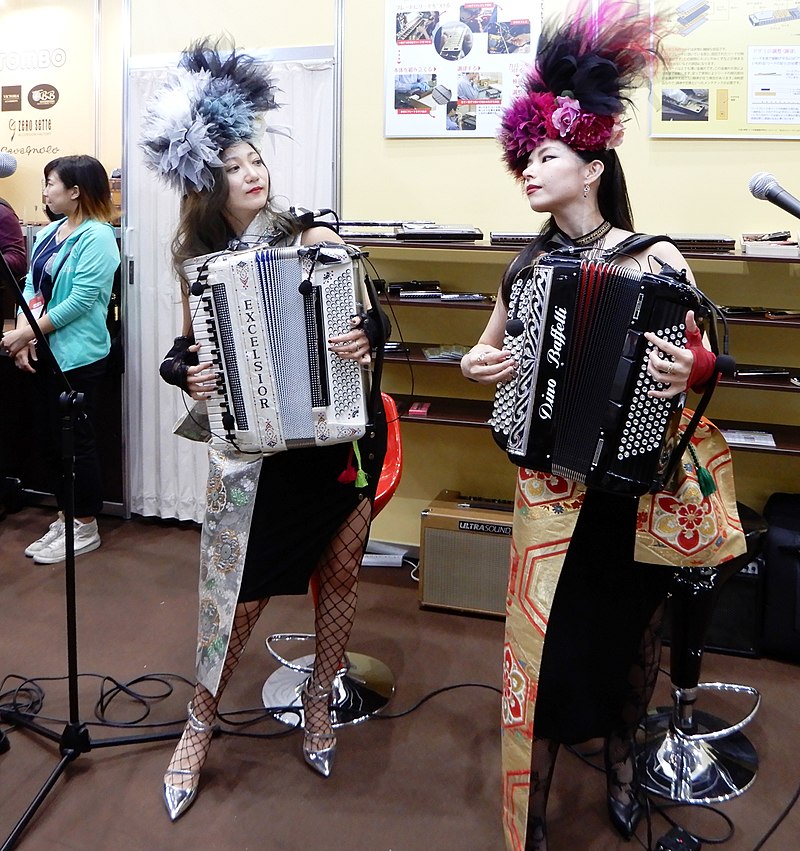 Two female playing accordion