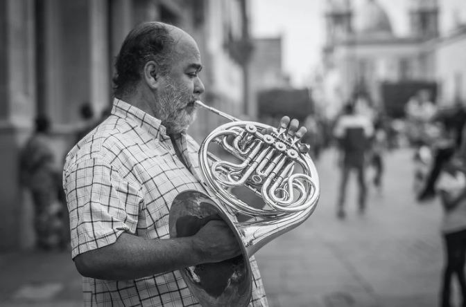 man playing a French horn