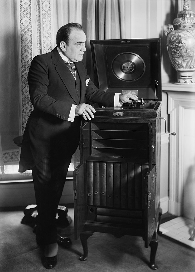 Enrico Caruso with a customized Victrola given to him as a wedding gift by the Victor Company in 1918